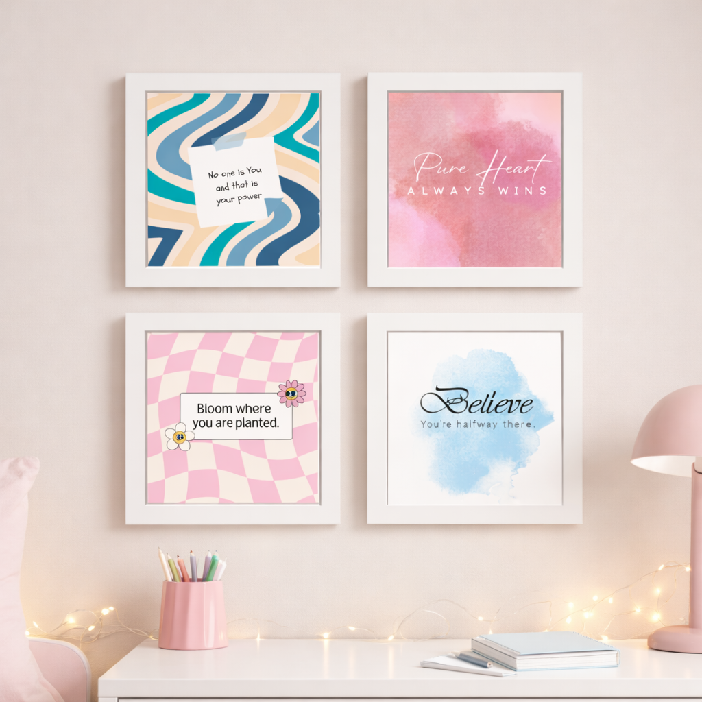 Four framed prints with motivational quotes on a wall above a desk.